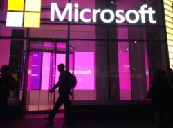 People walk past a Microsoft office in New York on November 10, 2016.