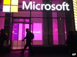 People walk past a Microsoft office in New York on November 10, 2016.