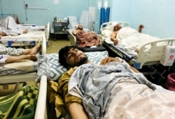 Wounded Afghans at a hospital after deadly suicide bombings outside the airport in Kabul killed at least 95 Afghans and 13 U.S. troops on August 26, 2021. (Mohammad Asif Khan/AP)