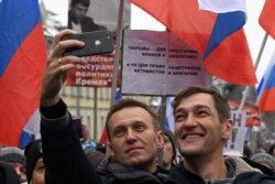 RUSSIA -- Russian opposition leader Alexei Navalny and his brother Oleg take a selfie picture during a march in memory of murdered Kremlin critic Boris Nemtsov in central Moscow on February 24, 2019.