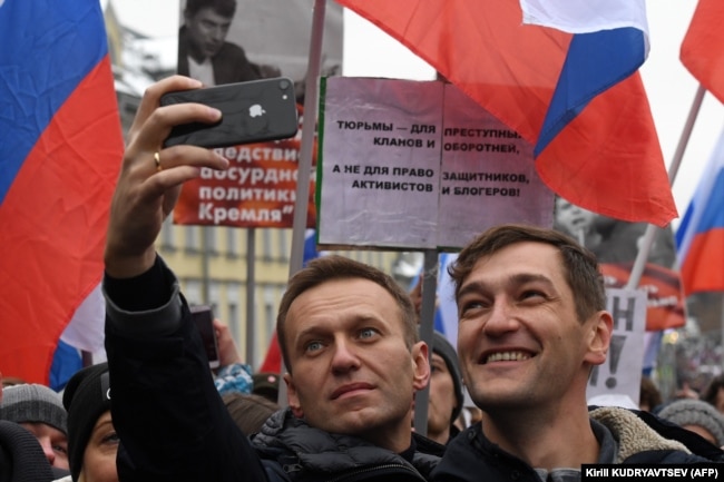 RUSSIA -- Russian opposition leader Alexei Navalny and his brother Oleg take a selfie picture during a march in memory of murdered Kremlin critic Boris Nemtsov in central Moscow on February 24, 2019.