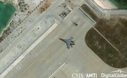 Satellite imagery shows what the CSIS Asia Maritime Transparency Initiative calls the deployment of several new weapons systems, including a J-11 combat aircraft, at China’s base on Woody Island in the Paracels, South China Sea on May 12, 2018.