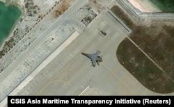 Satellite imagery shows what the CSIS Asia Maritime Transparency Initiative calls the deployment of several new weapons systems, including a J-11 combat aircraft, at China’s base on Woody Island in the Paracels, South China Sea on May 12, 2018.