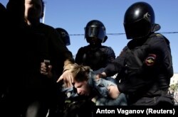 RUSSIA -- Police officers detain a participant during a rally held by LGBT activists and their supporters on the International Day Against Homophobia, Transphobia and Biphobia in central Saint Petersburg, Russia May 17, 2019.