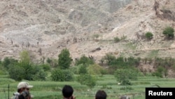Afghanistan -- Afghan Special Forces watch at the site where a MOAB, or ''mother of all bombs'', struck the Achin district of the eastern province of Nangarhar, April 23, 2017