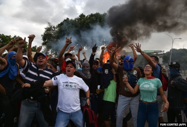 VENEZUELA -- Venezuelan opposition demonstrators, chant slogans during a protest against the government of President Nicolas Maduro, on the anniversary of 1958 uprising that overthrew military dictatorship in Caracas on January 23, 2019.