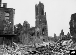 FRANCE -- Among the wreckage of St. Lo, France, on July 31, 1944, now being cleared by U.S. engineers, is the tower of Notre Dame Cathedral almost isolated. Shattered buildings are seen all around - evidence of the fierce fighting between American and Nazi forces.