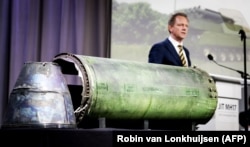 NETHERLANDS -- Head prosecutor Fred Westerbeke speaks next to a part of the BUK rocket that was fired on the Malaysia Airlines flight MH17 during the press conference of the Joint Investigation Team, in Bunnik, May 24, 2018