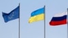 Flags of the European Union (L-R), Ukraine and Russia fly during the arrivals of leaders and delegations at an airport outside Minsk August 26, 2014. (Vasily Fedosenko/Reuters)