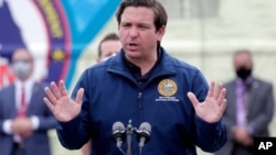 Florida Gov. Ron DeSantis speaks during a news conference at a COVID-19 testing site at Hard Rock Stadium, during the new coronavirus pandemic, May 6, 2020, in Miami Gardens, Fla.