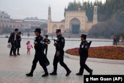 CHINA -- Uighur security personnel patrol near the Id Kah Mosque in Kashgar in western China's Xinjiang region, November 4, 2017