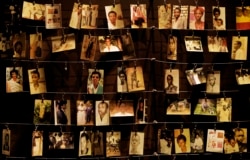 Family photographs of some of those who died hang on display in an exhibition at the Kigali Genocide Memorial center in the capital Kigali, Rwanda.