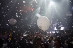 People dance at a nightclub, almost a year after the global outbreak of the coronavirus disease (COVID-19) in Wuhan, Hubei province, China, December 12, 2020.