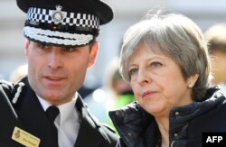 Britain's Prime Minister Theresa May is shown the areas in Salisbury where Skripal and his daughter went to and were discovered at after a nerve agent attack, March 15, 2018.