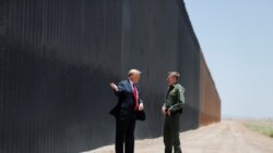 U.S. President Donald Trump talks with U.S. Border Patrol Chief Rodney Scott as he tours a section of the U.S.-Mexico border wall.
