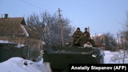 UKRAINE -- Ukrainian servicemen ride on a armoured personnel carrier (APC) in the town of Mariinka, Donetsk region, located on the front line with Russian-led forces, January 18, 2019