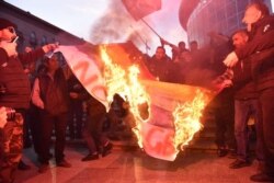 Georgia -- antigay protesters burn LGBT flag.