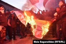 Georgia -- antigay protesters burn LGBT flag.