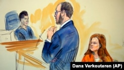 U.S. -- A courtroom sketch depicts Maria Butina, listening to Assistant U.S. Attorney Erik Kenerson as he speaks to Judge Deborah Robinson, left, during a hearing in federal court in Washington, July 18, 2018.