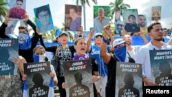 People hold pictures of protesters who died during demonstrations against Nicaraguan President Daniel Ortega's government during the previous year in Managua, Nicaragua, on November 2, 2019. (Oswaldo Rivas/Reuters) 