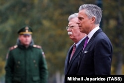 RUSSIA -- U.S. National Security Adviser John Bolton and U.S. Ambassador to Russia Jon Huntsman attend a wreath-laying ceremony at the Tomb of the Unknown Soldier by the Kremlin wall in Moscow, October 23, 2018