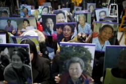 South Korea -- Students hold portraits of deceased former South Korean "comfort women" during a weekly anti-Japan rally in front of Japanese embassy in Seoul, South Korea, December 30, 2015..