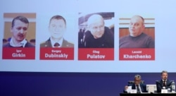 NETHERLANDS -- Russian nationals Igor Girkin, Sergey Dubinskiy and Oleg Pulatov, as well as Ukrainian Leonid Kharchenko, accused of downing of flight MH17, are shown on screen as international investigators present their latest findings in the case.