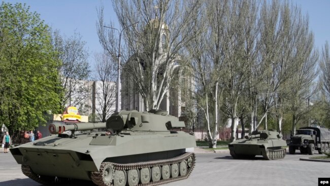 Ukraine -- Pro-Russian armored military vehicles ride in Donetsk, April 27, 2015