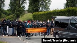 Volunteers of the Tahara association pray for 38-year-old Abukar Abdulahi Cabi, a Muslim refugee who died of the coronavirus disease (COVID-19), during a burial ceremony in a cemetery in La Courneuve, near Paris, France, May 17, 2021.