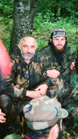 In this undated photo, Zelimkhan Khangoshvili (rear) is shown seated alongside Aslan Maskhadov (front) who served briefly as president of Chechnya in the 1990s.