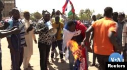Protesters seen setting the French flag on fire during an anti-France protest in Central Ouagadougou on January 20, 2023.
