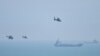 Chinese military helicopters fly past Pingtan Island on August 4, 2022, ahead of massive military drills off Taiwan. Pingtan Island is part of Fujian Province and one of China's closest points to Taiwan. (Hector Retamal/AFP