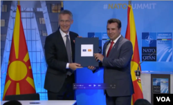NATO Secretary General Jens Stoltenberg and North Macedonia's Prime Minister Zoran Zaev sign an accession protocol in Brussels.