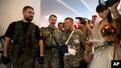 UKRAINE – Igor Strelkov, 2nd left, attends the wedding ceremony of now-deceased platoon commander Arsen Pavlov, also known as Motorola in the city of Donetsk, eastern Ukraine, on July 11, 2014.