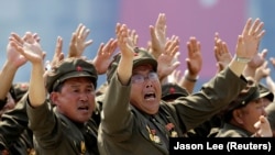 Korean War veterans react as they shout slogans to North Korean leader Kim Jong Un during a parade to mark the 60th anniversary of the signing of a truce in the 1950-1953 Korean War, at Kim Il Sung Square in Pyongyang, North Korea. (Jason Lee/Reuters)