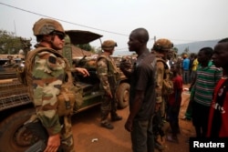 Angry young men complain to French soldiers on patrol in Bangui on February 15, 2014. (Luc Gnago/Reuters)
