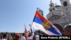 Montenegro -- Orthodox believer is carrying the Serbian flag in front of the Cathedral of the Resurrection of Christ in Podgorica, June 15, 2019.