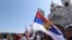 Montenegro -- Orthodox believer is carrying the Serbian flag in front of the Cathedral of the Resurrection of Christ in Podgorica, June 15, 2019.