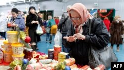 A woman counts money at a food fair in the village of Ulyanovka, south-east of Stavropol, Russia December 22, 2015
