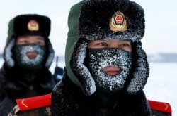 Chinese paramilitary police border guards train in the snow at Mohe County in China's northeast Heilongjiang province, China, on the border with Russia on December 12, 2016.