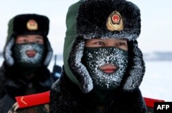 Chinese paramilitary police border guards train in the snow at Mohe County in China's northeast Heilongjiang province, China, on the border with Russia on December 12, 2016.