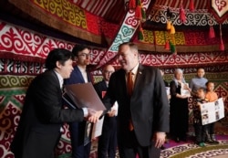 Former U.S. Secretary of State Mike Pompeo meets with Kazakh citizens who said their family members have been detained in Xinjiang, China, in a yurt at the U.S. Ambassador's residence in Nur-Sultan, Kazakhstan on Feb. 2, 2020.