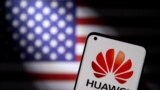 Smartphone with a Huawei logo is seen in front of U.S. flag in this illustration. (Dado Ruvic/Reuters)