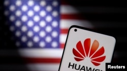 Smartphone with a Huawei logo is seen in front of U.S. flag in this illustration. (Dado Ruvic/Reuters)