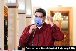 Venezuelan President Nicolas Maduro wearing a face mask while speaking during a televised announcement over the global COVID-19 pandemic, in Caracas, Venezuela on March 13, 2020.