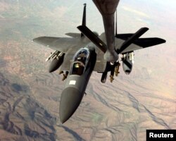 A U.S. Air Force F-15E Strike Eagle refuels in-flight from a KC-135R Stratotanker in the skies over Macedonia, on March 26, 1999, as the two aircraft fly missions in support of NATO Operation Allied Force against targets in the Federal Republic of Yugoslavia.