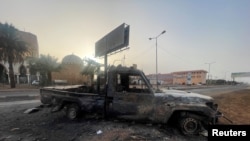 A burned vehicle is seen in Khartoum, on April 26, 2023. (El-Tayeb Siddig/Reuters)