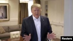 FILE PHOTO: U.S. President Donald Trump makes an announcement from the Walter Reed National Military Medical Center, where he was being treated for COVID-19, in Bethesda, Maryland, U.S. October 4, 2020, in this still image taken from a video posted on Trump's twitter page.
