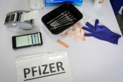 Doses of the Pfizer coronavirus (COVID-19) vaccine are seen at a mass vaccination site supported by the federal government at the Miami Dade College North Campus in Miami on March 10, 2021.