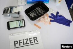 Doses of the Pfizer coronavirus (COVID-19) vaccine are seen at a mass vaccination site supported by the federal government at the Miami Dade College North Campus in Miami on March 10, 2021.